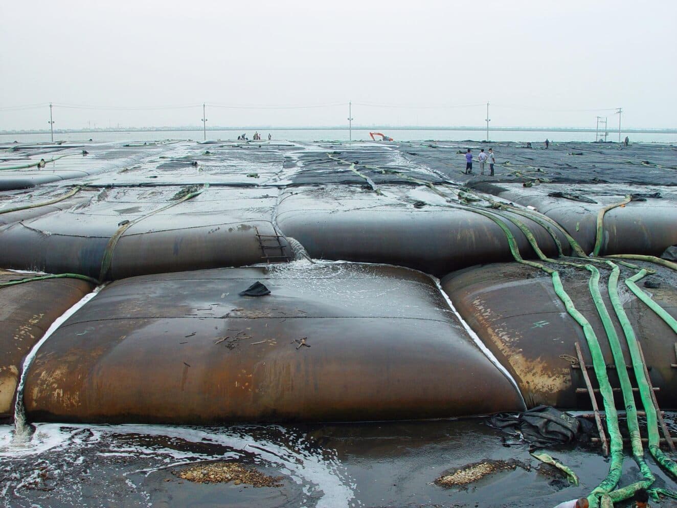 The GEOTUBE dewatering containers were used to contain the dredged slurry and remove water from the material, achieving a consistency similar to compacted borrowed material.